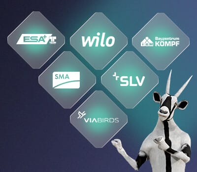 Logos of ESA, Wilo, Bauzentrum Kömpf, SMA, SLV, Viabirds, and Spryker with an illustration of a goat on a blue gradient background.